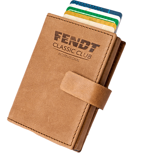 The AGCO Fendt - Card holder with RFID protection (X991023037000) features a sophisticated tan leather design with "Fendt Classic Club International" embossed on the front. This stylish and secure holder, partially open to reveal several credit cards inside, seamlessly combines both style and security.