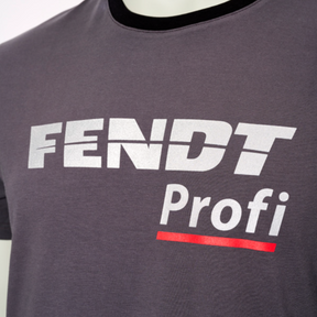 Close-up of a person wearing an AGCO Fendt - Profi T-shirt in grey and black, featuring the text "FENDT Profi" in white and red letters, designed for high wear comfort.