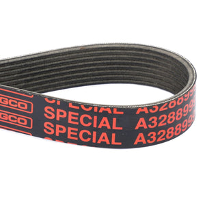 Close-up of a black and red AGCO serpentine belt labeled "SPECIAL" and "A3288999." The belt is coiled in a loop with visible ribs on its inner surface. The product is referred to as AGCO | Serpentine Belt, 8Pk, Black, Aramid Cord - A3288999. No current product description available.