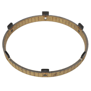 The AGCO | Cone - 3902682M1 is a circular metal ring featuring evenly spaced rectangular tabs on the inner edge, evocative of a Massey Ferguson component. It has a small hole on its edge and exhibits slight surface wear.