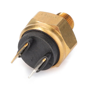 Close-up image of an AGCO | Temperature Activated Switch - 3595187M1, featuring a brass and black design with two metal prongs, similar to an electrical connector used in Massey Ferguson models.