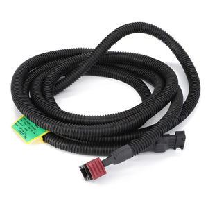 The AGCO | Harness - Act0023720, featuring a coiled black corrugated wire conduit with red and black connectors on each end, enhances machinery reliability with AGCO Parts Genuine Electrics.