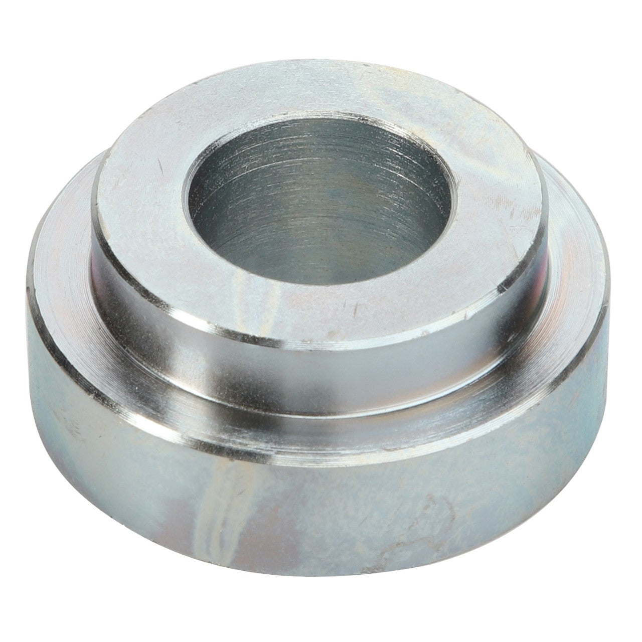 AGCO | SPACER - D28480457 by AGCO is a metal spacer with a central hole, engineered for precise insertion into various structures to maintain distance or provide robust support.