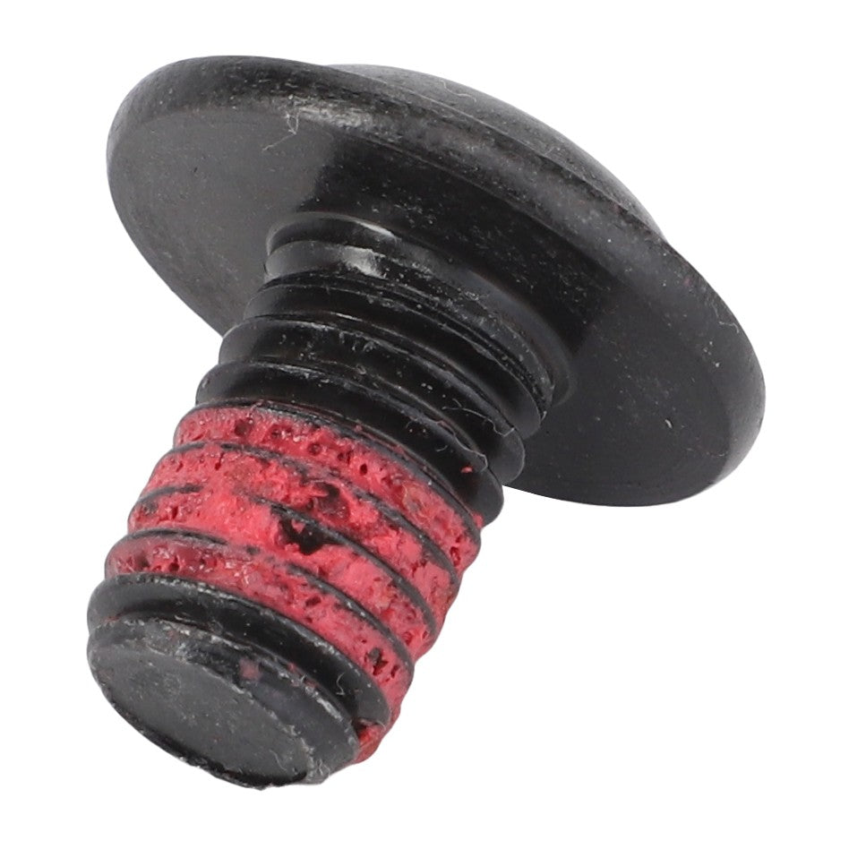 A close-up of an AGCO Torx Head Screw - Acx2570390 with a flat head and red adhesive meticulously applied to the threaded part.