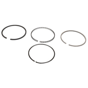 Four AGCO metal piston rings from the KIT, RING - 0.008.0052.6 are arranged in a horizontal line, each varying slightly in thickness and design. For any questions or assistance with ordering, please contact our support team. The background is white.