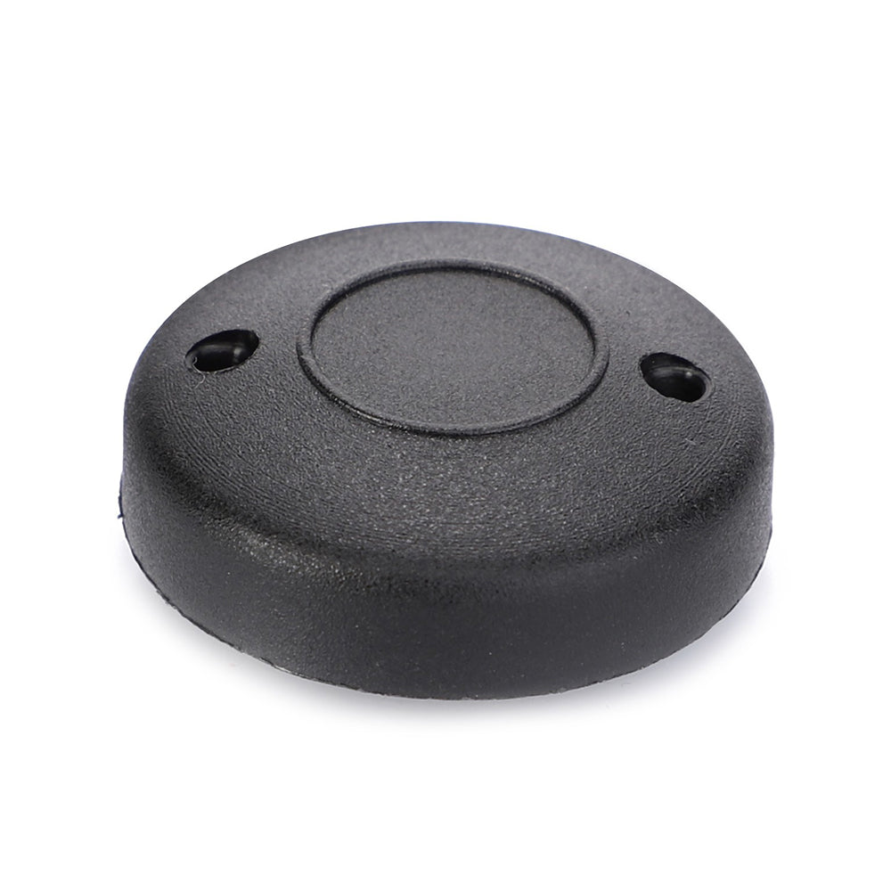 A Massey Ferguson - Button (3805521M1) by AGCO is a small, round, black plastic object with two holes near the edge, likely serving as a cover or cap for a Massey Ferguson device.