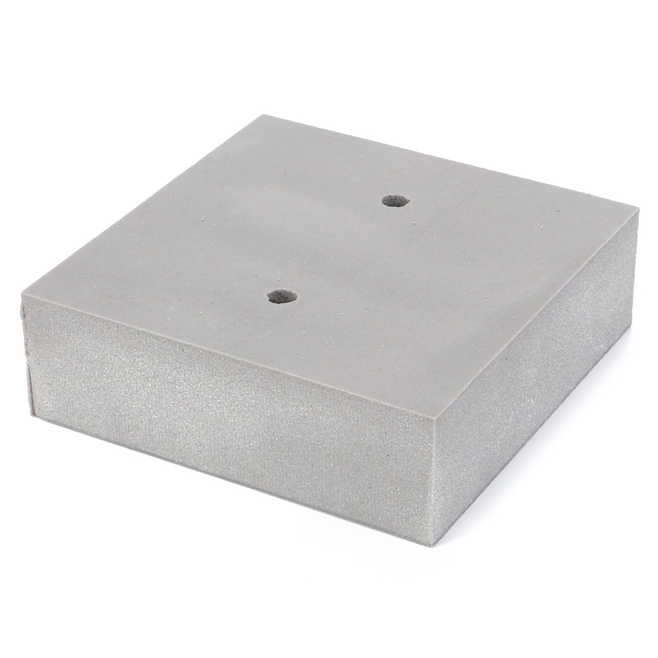 A gray, rectangular foam block with two small holes drilled in the center, reminiscent of the precision seen in AGCO's Plate - 4271078M1.