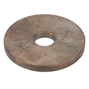 The AGCO | Washer - Acw1701240 is a large, flat, round metal washer with a central hole. The surface appears worn and tarnished.