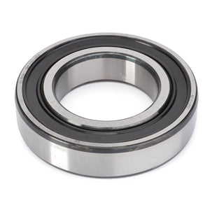 The AGCO Ball Bearing - F281108220010 is a metal ball bearing with an inner and outer ring, designed to handle radial and axial loads, and features a rubber seal on one side.