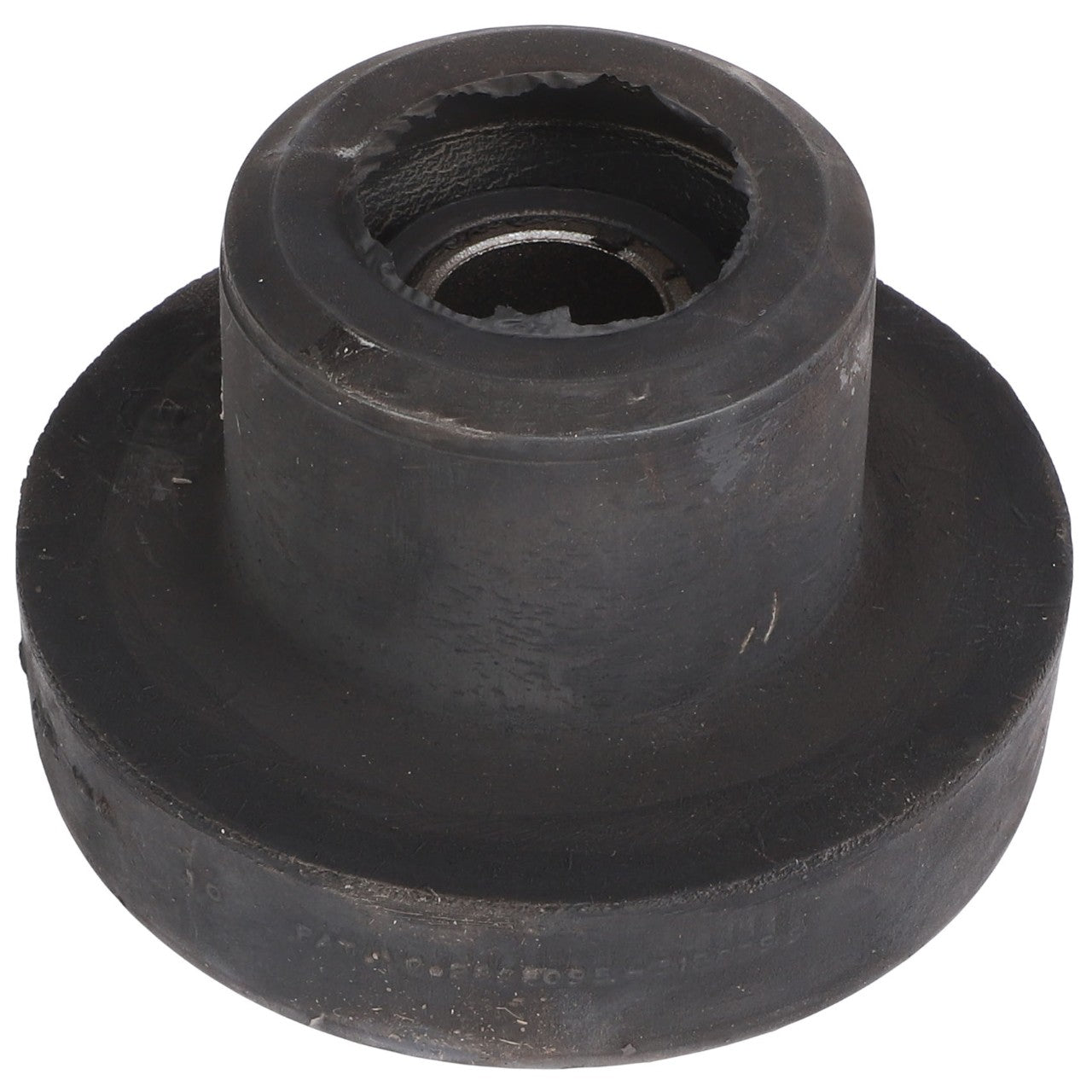 Close-up of an AGCO | BONDED MOUNT - AG519388, a black, cylindrical rubber bushing with a metal core, showing wear and tear around the edges. No current product information is available for this specific item.