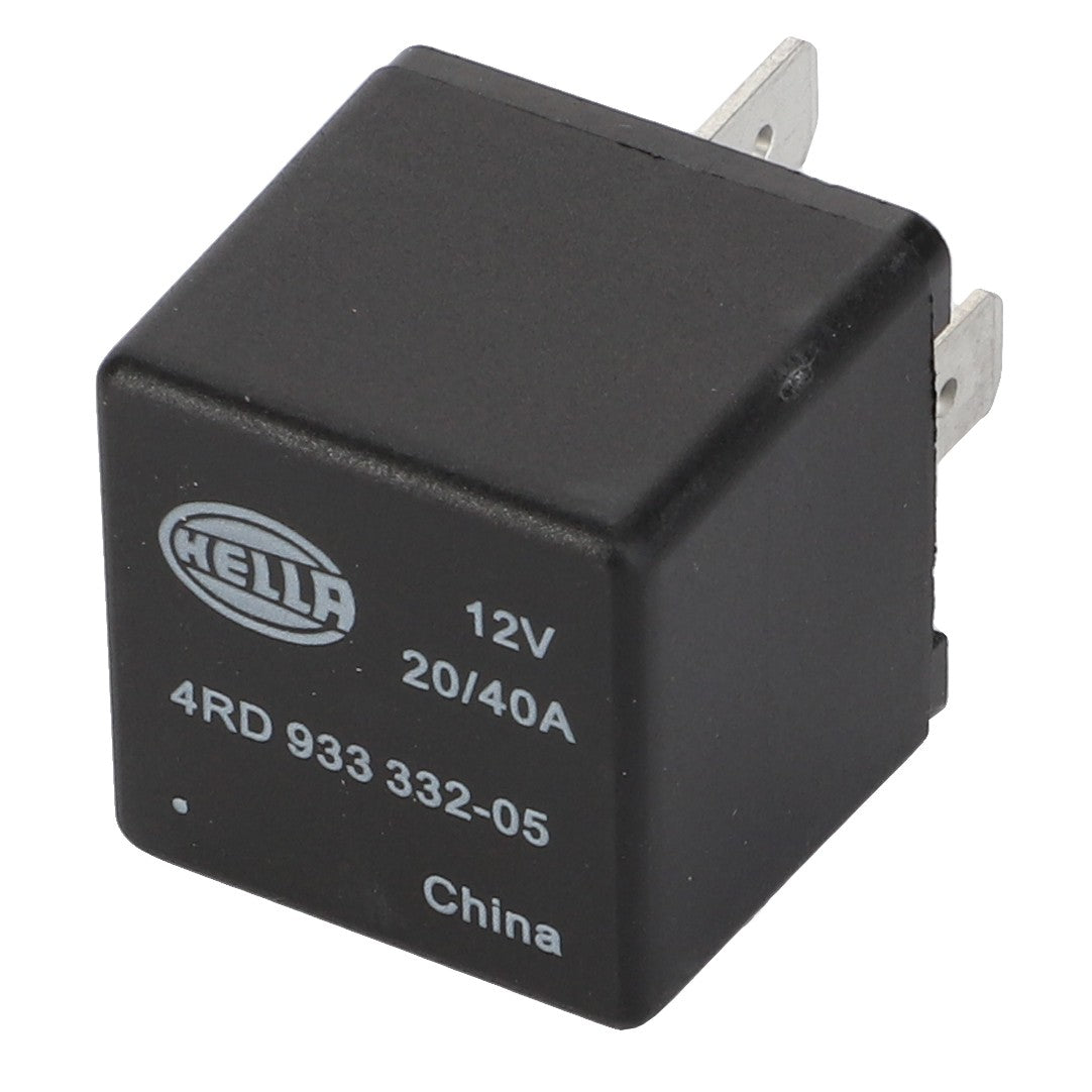 A black, cubic relay with the text "HELLA 12V 20/40A 4RD 933 332-05 China" printed on its surface. Designed for optimal integration, this component features metal prongs on one side for electrical connections and is part of the AGCO Parts Genuine Electrics lineup. The official product name is AGCO | Relay, 12 V 20/40 A - D45087700 from the brand AGCO.