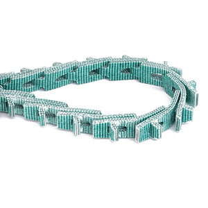 The AGCO | Drive Belt, Radiator Filter Transmission - D28786813 is a segmented green and white industrial belt coiled in a U-shape, designed for machinery to ensure optimal performance while reducing noise and slippage.