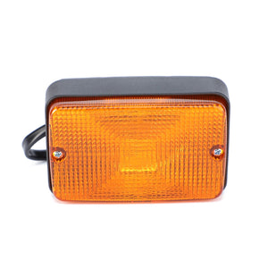 A rectangular amber-colored AGCO Turn Signal - Acw0152020 featuring screw attachments on both sides and a black plastic housing ensures reliability and safety for your vehicle.