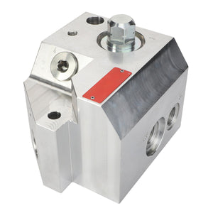 A polished metallic mechanical component block with multiple holes and a red rectangular label: AGCO | Valve - Acp0667830 by AGCO.