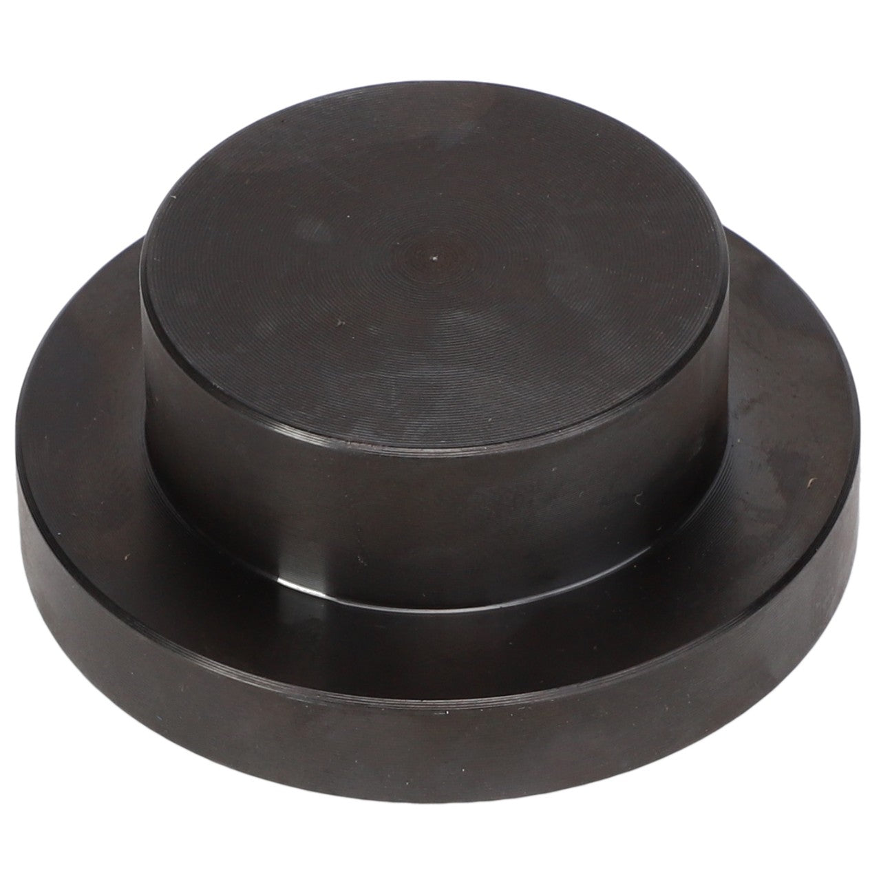 The AGCO Seal Kit - Acp0437710 is a round, black metallic disc featuring a raised circular section in the center, resembling a large button or cap.