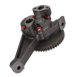 A close-up of a metal automotive part, featuring a gear and several mounting points. Product: AGCO Lubricating Oil Pump - Acw1838790, Brand: AGCO.