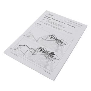 The manual titled "AGCO | Fit.Instruction - Act001375B" is laid flat and open to a page featuring diagrams and text on fitting the Power Beyond Kit to a CVT Tractor. The cover currently lacks a product description.