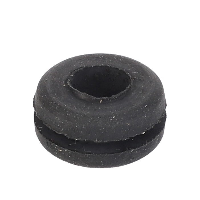 Close-up of the AGCO Grommet - 3477717M1, a black rubber grommet with a central hole and a split groove around its circumference, ideal for use in Valtra models.