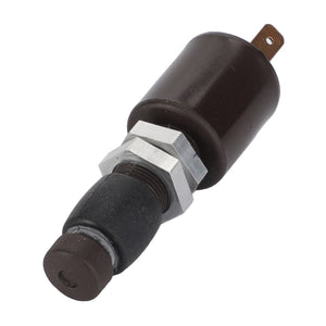 The AGCO | Switch - D26733124, a cylindrical black electrical component featuring a metal nut and rubber end, is photographed against a pristine white background.