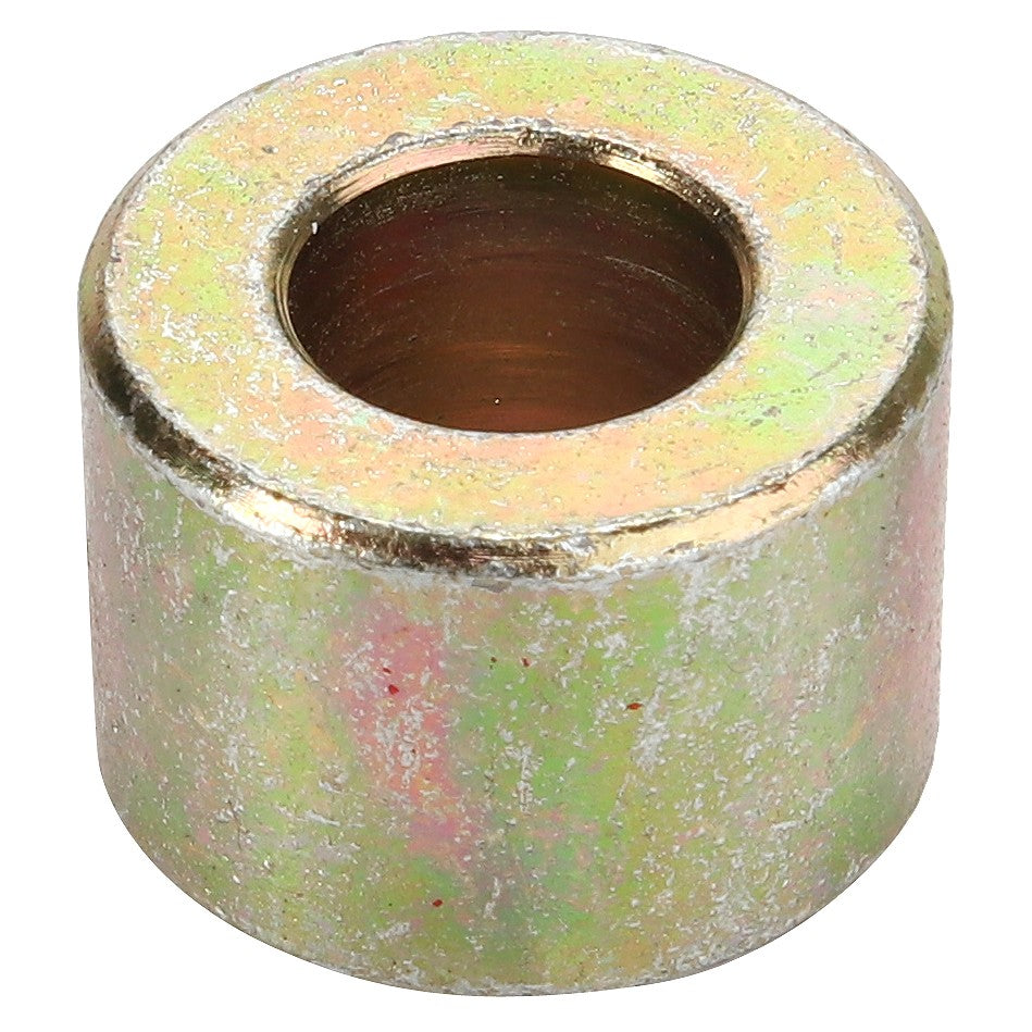 The AGCO | SPACER - D28250794 is a cylindrical metallic spacer with a large central hole, exhibiting a slightly worn, reflective surface. Additional product description information is currently unavailable.