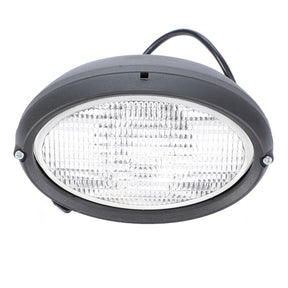 Introducing the AGCO Work Light, model 4384409M1, an oval-shaped LED light featuring a ribbed clear lens housed in a sleek black casing. It includes two mounting screws and a black cable extending from the back. This front work light comes equipped with an H3 12V 55W bulb and is ideal for use as genuine AGCO work lights on Massey Ferguson or Valtra models.