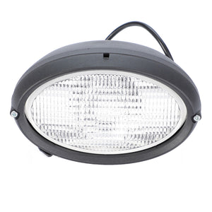 Introducing the AGCO Work Light, model 4384409M1, an oval-shaped LED light featuring a ribbed clear lens housed in a sleek black casing. It includes two mounting screws and a black cable extending from the back. This front work light comes equipped with an H3 12V 55W bulb and is ideal for use as genuine AGCO work lights on Massey Ferguson or Valtra models.