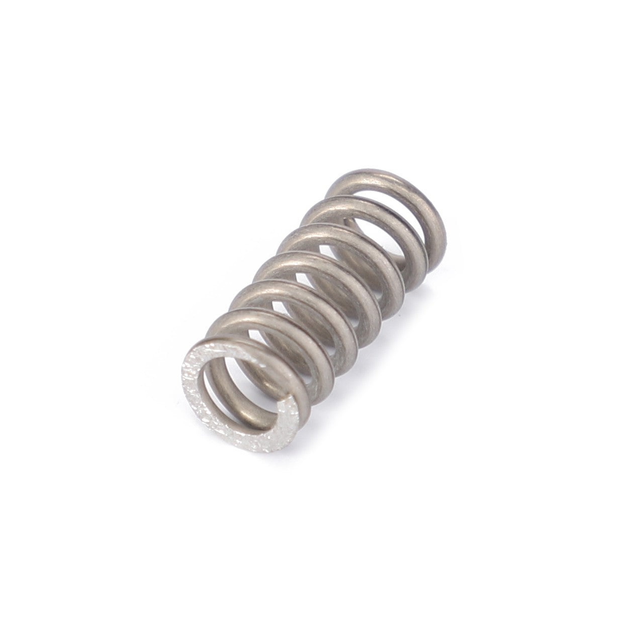 A metal compression spring, coiled with closely spaced turns, lies on a white background, showcasing precision akin to the engineering of an AGCO Compression Spring - 945870030050.