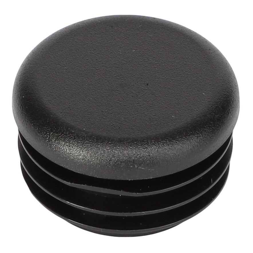 The AGCO | CAP - AG059020 is a black plastic end cap with a round top and ribbed sides, designed for enclosing the end of a cylindrical tube. Brand: AGCO. No current product description information is available.