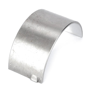 A curved, metal, rectangular-shaped AGCO Conrod Bearing - 3604433M1 with a small tab at one end, placed on a white background.