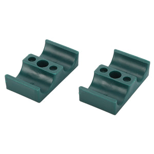 Two AGCO CLAMP - D45730013 green plastic mounting brackets with grooved cylindrical slots and multiple screw holes, displayed side by side on a white background. No current product description information is available for further details.