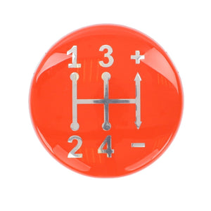 The AGCO Cap, Controls & Levers - 3821980M1 is a red gear shift knob featuring a diagram of a four-speed manual transmission pattern, numbered 1 through 4 with plus and minus symbols, designed for use with Massey Ferguson Models.