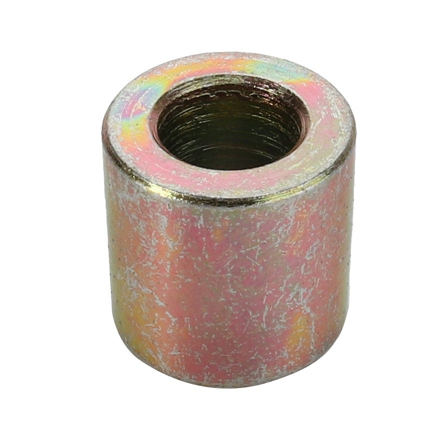 The AGCO BUSH - D26733466 is a cylindrical metal spacer featuring a threaded hole in the center. It has a slightly rough surface and boasts a metallic, multicolored finish. Currently, there is no information available regarding its availability or specifications.