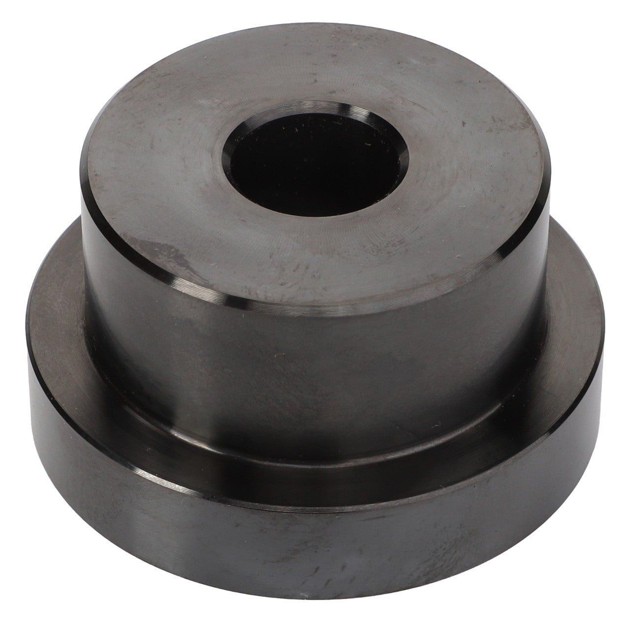 A cylindrical metal component with a central hole, resembling a mechanical part or spacer, called the AGCO | Tool - Acp0446460 by AGCO.