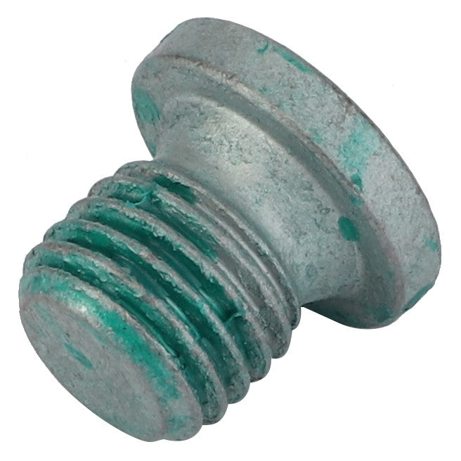 A close-up of a weathered, cylindrical AGCO Plug Screw - F530200090370 with a flat head and visible green corrosion on the threads.