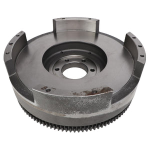 The AGCO Flywheel - 4271845M92 features visible gear teeth and multiple mounting holes, making it compatible with Massey Ferguson models. The surface shows signs of wear and minor rusting.