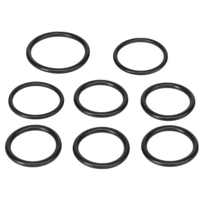 The AGCO SEAL KIT - F718100600010, featuring eight black rubber O-rings, is meticulously arranged in a circular pattern on a pristine white background, creating a striking visual contrast.