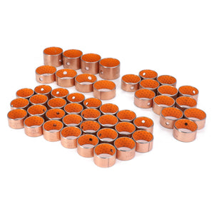 A collection of AGCO metal cylindrical bushings, model AL5018913, accented with vibrant orange interiors, meticulously arranged in neat rows on a pristine white surface.