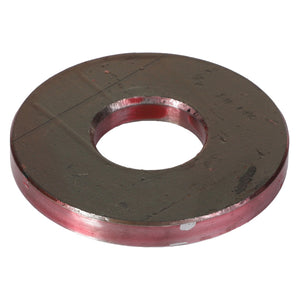 A flat, circular metal washer with a central hole and reddish edges, showing signs of wear and slight scratches. Product Name: AGCO Flat Washer - Acp0018820 by AGCO.