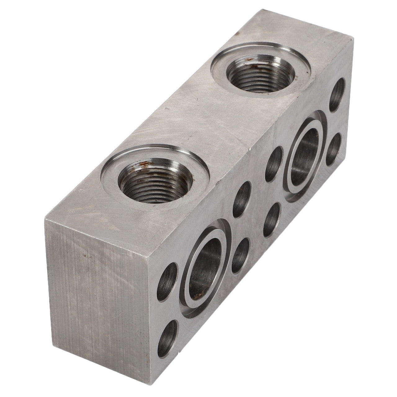 AGCO | ADAPTER - D28187335 is a rectangular metal hydraulic manifold block featuring cylindrical openings, multiple ports, and threaded connections to facilitate the flow and distribution of hydraulic fluid. Brand Name: AGCO. No current product description information is available.