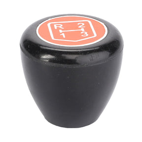 Close-up of a black gear shift knob from AGCO, featuring a red and white gear pattern displaying positions for reverse, 1st, 2nd, and 3rd gears. This product, named AGCO | Knob, Transmission - 3599997M2, is designed to enhance productivity and efficiency.