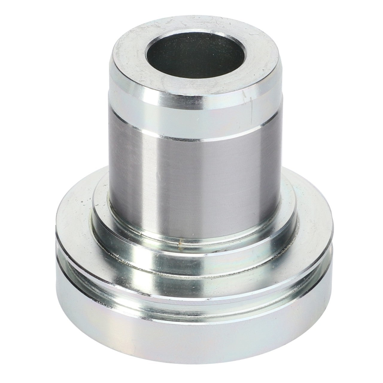 The AGCO Bearing Bushing - 931502200050 is a cylindrical metal part with a larger base, featuring a central hole and a smooth, shiny surface, commonly used as bushings in Fendt models.