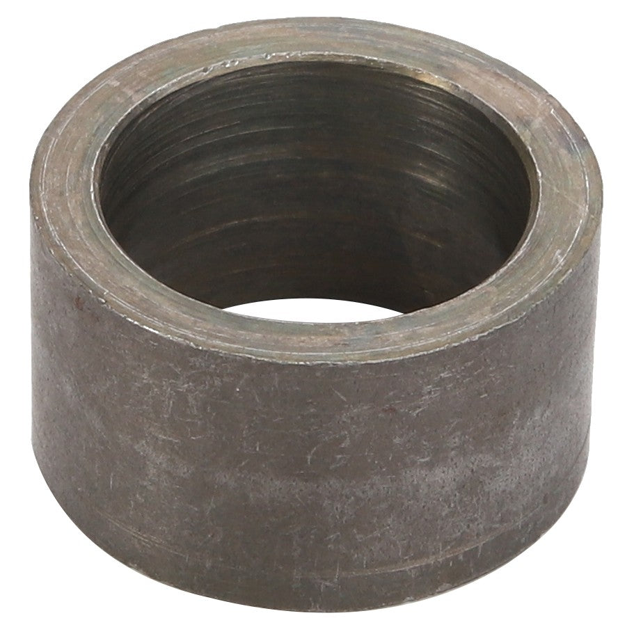 The AGCO SPACER - D28782757 is a cylindrical metal ring-shaped component with a rough, slightly tarnished surface. The interior is threaded, indicating it serves a mechanical purpose. Detailed product description information for this AGCO item is currently unavailable.