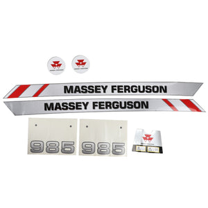 A variety of AGCO decals, specifically designed for the Massey Ferguson 985 Front Loader (AL11133963), featuring factory-engineered brand name decals, circular logos for optimal visibility, "985" number decals, and a safety warning label.