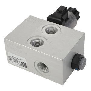 Close-up view of the AGCO Valve Block - Acw1982320, a rectangular metal hydraulic valve block with multiple ports and a black electronic connector on top. No current product description information is available.