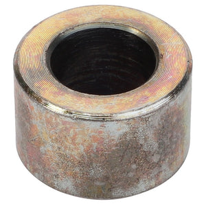 The AGCO Spacer Tube - Fel140180, a cylindrical metal object with a central hole, features a weathered or corroded surface. No current product description is available.