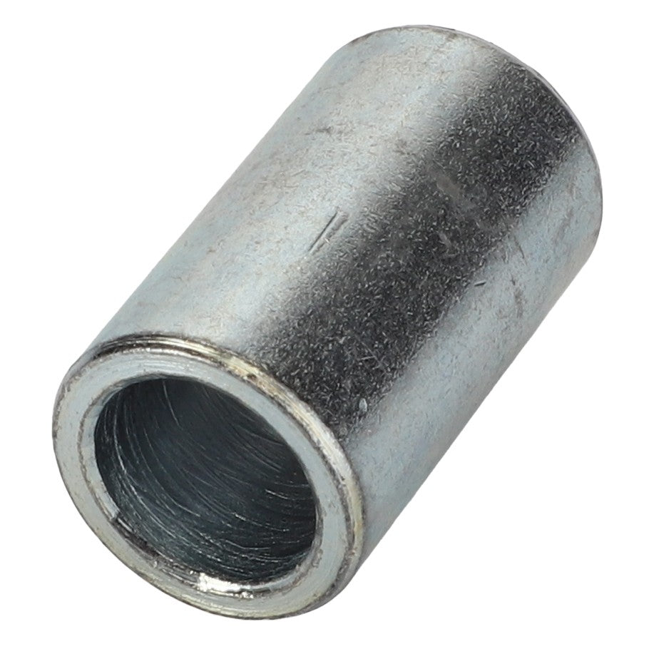 A metallic cylindrical spacer with a hollow core and a slightly textured surface, showing wear. Product: AGCO | Ratchet Jack Spacer Bushing - Sf10060015A, Brand: AGCO.