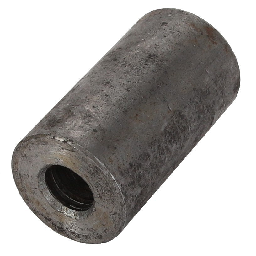 The AGCO Spacer Piece - V836328372 is a cylindrical metal spacer that features a threaded interior and a rugged exterior surface.