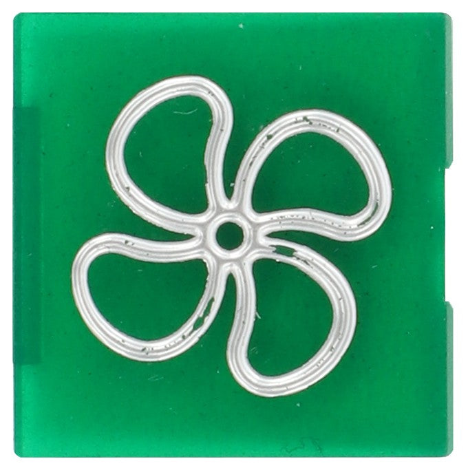 A green square tile featuring a silver outline of a four-petal flower in the center, now identified as the AGCO Symbol Lens for an Air Circulation Fan - V30944900. Further product description details are currently unavailable.