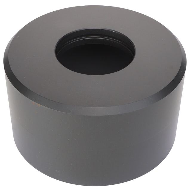 This is an AGCO | Piston Housing - Acw9087410, a cylindrical metal object with a large central hole. The top and bottom surfaces are flat, and the sides are smooth. Currently, no additional product description information is available for this item.