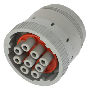 Close-up of a circular gray AGCO | CONNECTOR - AG520349 multi-pin electrical connector, featuring six pin sockets arranged in a circular pattern, with an orange inner lining.